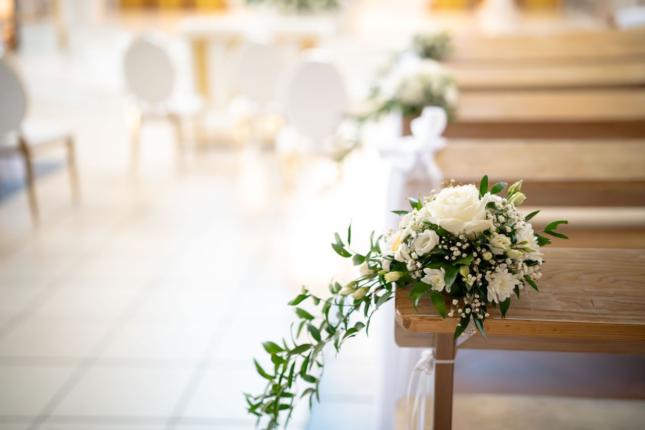 The Art of Drawing Readers In: Your attractive post title goes here Beautiful floral arrangement on a wedding aisle with delicate white roses and greenery.
